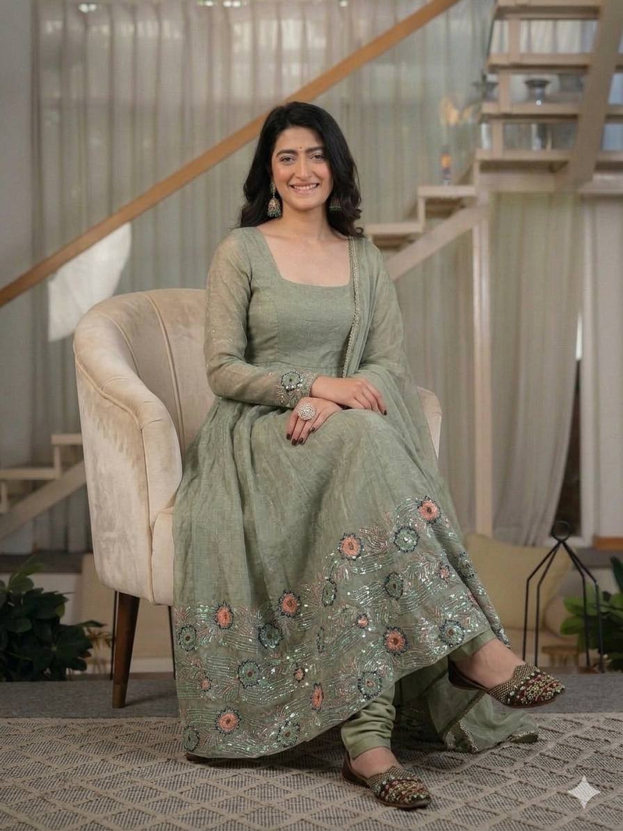 Ethereal Mehendi Green Flared Anarkali Suit Set Adorned with Luminous Sequined Floral Motifs, Embroidered Cuffs, and an Ornate Heritage Hem